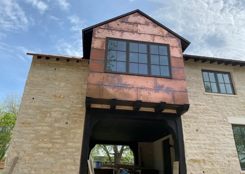 Copper metal panel facade on a stone building for Skylight Installation in South Apopka